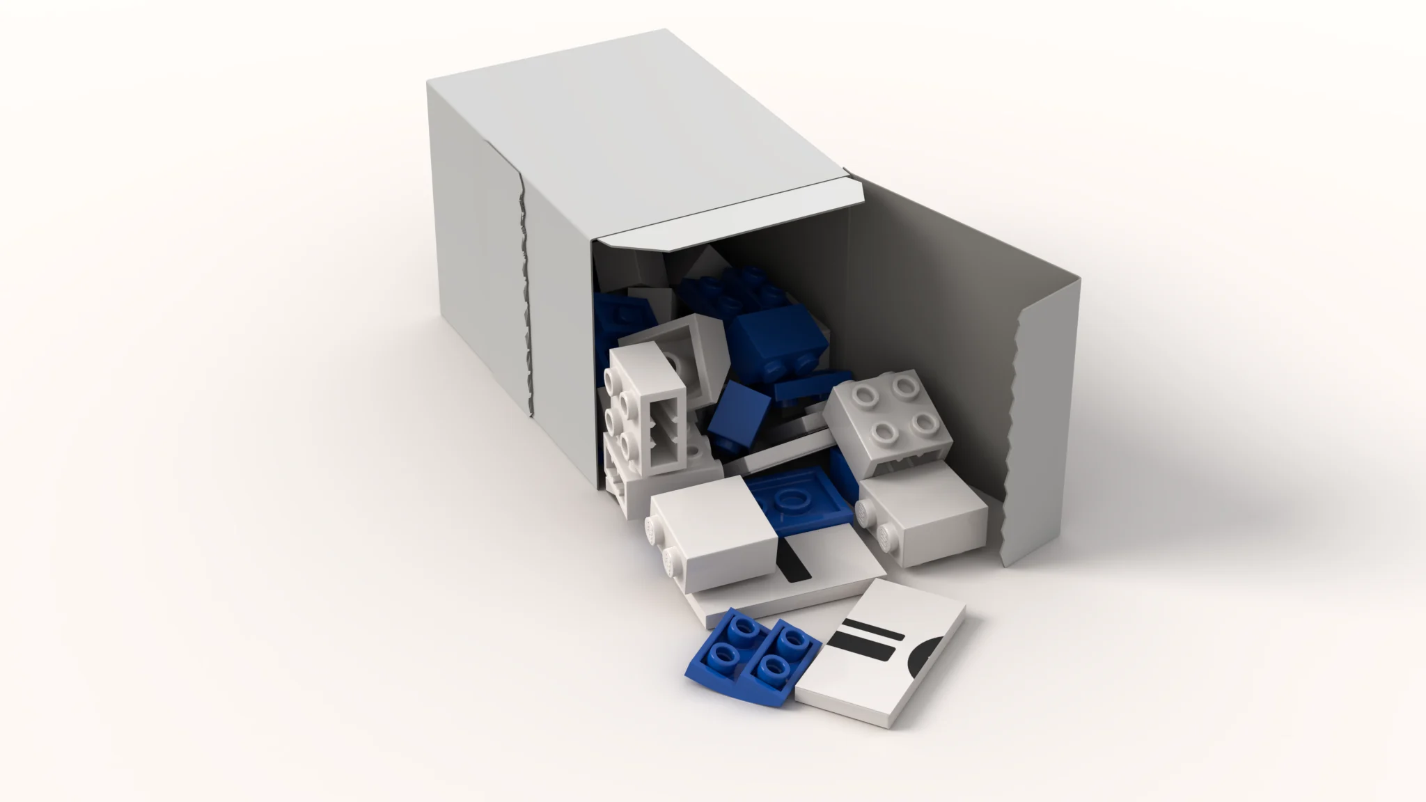 A small white kit box lying on its side, opened at its small end, with white and blue bricks poured halfway out and two printed tiles in front.