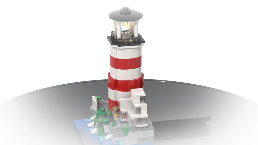 A commissioned lighthouse in red and white on a rocky base, built from LEGO® bricks.